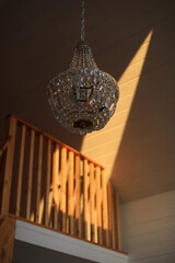 Texture, pattern, background. light crystal chandelier with blurred focus. Glamour background with copy space.