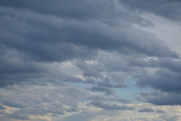 A blue patch of sky peeks out from under the grey clouds