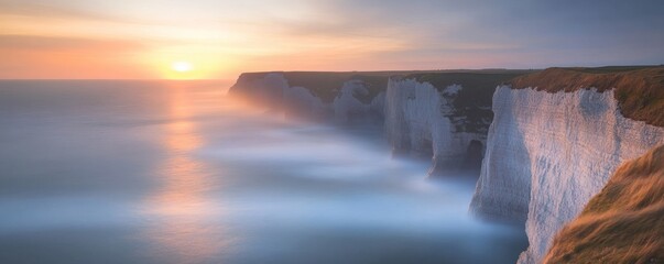 Fototapeta premium Dramatic coastal cliffs overlook the sea during a beautiful sunset