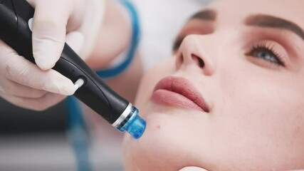 A woman receiving a hydrafacial treatment in a beauty salon. Concept of effective hydration and skin rejuvenation using modern technologies for the perfect facial care.