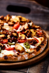 Gyros Pizza with jalapeno pepper, cherry tomatoes and mozzarella cheese. Soft focus. Close up.