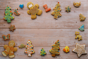 Ornament of multi-colored glazed cookies on a light wooden background