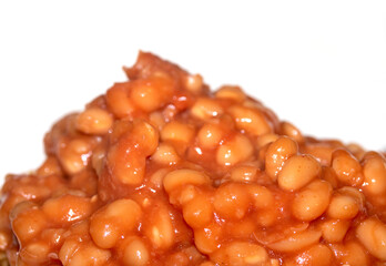Close up of tomato baked beans on white background