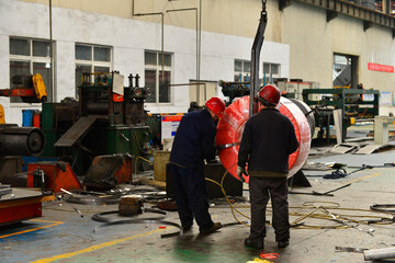 Workers on the production line of the strip steel coil factory are working