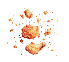 Crispy fried chicken leg and thigh with golden breadcrumbs against black background, cut out