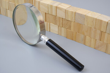 Wooden wall under magnifying glass. Check sarety and defence concept.	