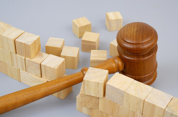 Wooden judge gavel breaking bricks wall. Freedom concept.