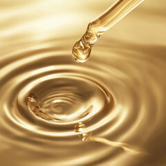 dropper releasing droplet into golden liquid, creating ripples