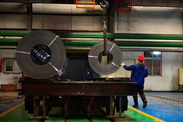 Workers on the production line of the strip steel coil factory are working