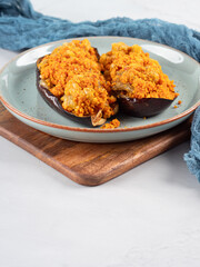 Baked eggplants stuffed with corn couscous with chickpea sauce