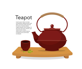 Ceramic teapot and a steaming cup of green tea on wooden board.