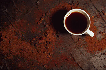 Morning energy. Beans and ground coffee on a dark backdrop