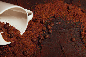 Coffee chaos, scattered grains and ground coffee close-up