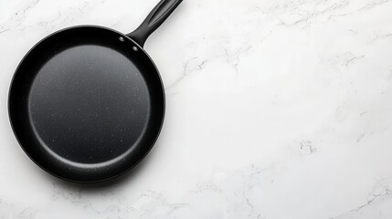 Topdown view of a nonstick saute pan, modern design, sitting neatly on a clean white surface