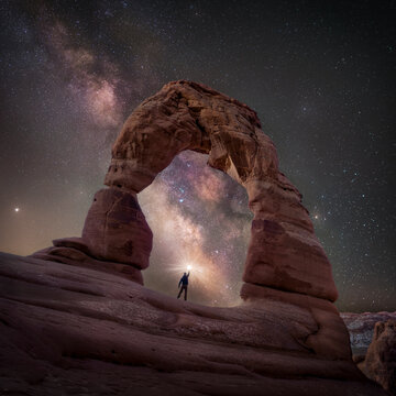 View of Delicate Arch under a breathtaking night sky filled with the Milky Way and stars, Moab, Utah, United States.