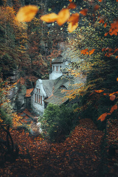 View of a picturesque autumn scene with a charming stone house nestled among vibrant foliage, Bohemian Switzerland, Hrensko, Czech Republic.