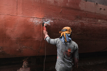 Dhaka, Bangladesh - 18 February 2025: View of shipyard workers engaged in ship maintenance and repair, Dhaka, Dhaka Province, Bangladesh.