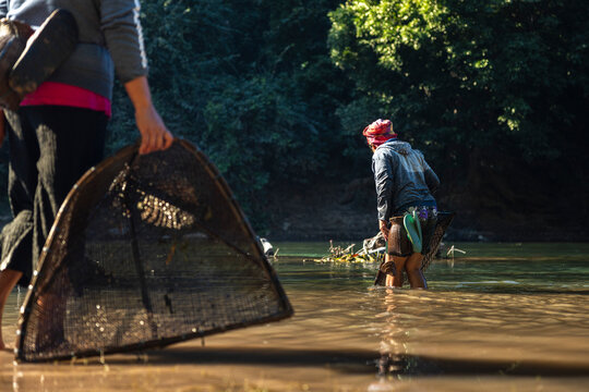 View of Laos people fishing for shrimp in the local river near Kong Lor cave, Laos, Southeast Asia