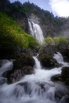 View of Selca waterfall surrounded by lush greenery and majestic rocks, Shkoder, Albania.