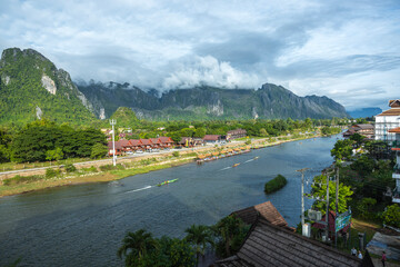 View of boats on the Nam Song River in Vang Vieng during sunrise Laos, Southeast Asia
