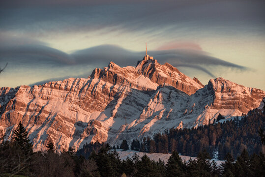 View of majestic Santis mountain at sunset surrounded by snow and clouds, Schwantlen, Thurgau, Switzerland.