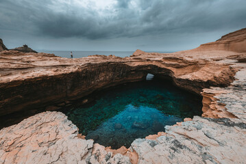 View of dramatic coastline with rugged rock formations and crystal clear water, Bonifacio, Corsica, France.