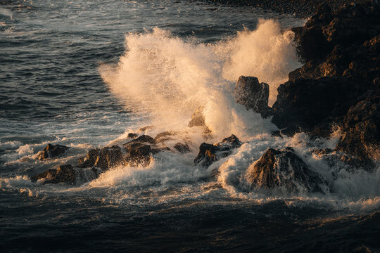 View of crashing waves on rugged rocks at sunset, El Golfo, Lanzarote, Spain.