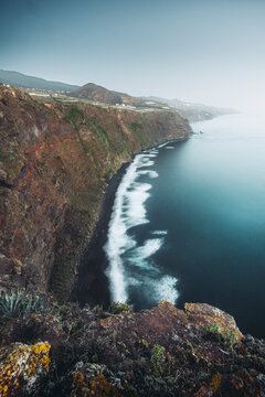 View of breathtaking rugged cliffs and serene ocean waves along the picturesque coastline, Mirador de la Playa de Nogales, Santa Cruz de la Palma, Spain.