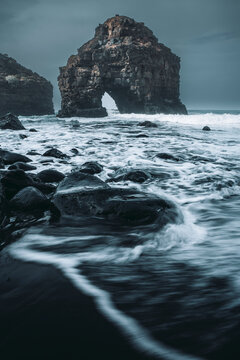 View of dramatic rock formations and powerful waves at the rugged coast, Playa de los Roques, Santa Cruz de Tenerife, Spain.