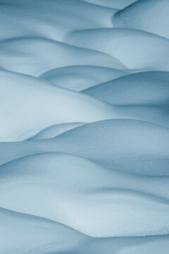 View of serene snowdrifts with smooth curves in a tranquil winter landscape, Morteratsch, Graubunden, Switzerland.