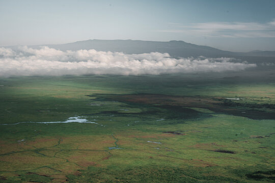 View of tranquil grassland and clouds under a serene sky, Manyara, Arusha, Tanzania.