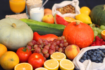 Various healthy fruits, vegetables and cereals on dark background. Selective focus.