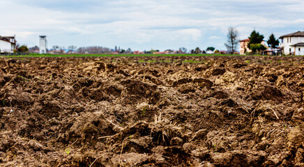 Dug up fertile land are ready for planting vegetable plants in Italy. Agricultural work in spring....