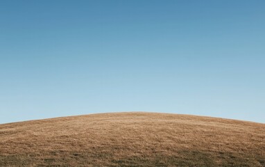 Fototapeta premium Barren Brown Hill Against Clear Blue Sky