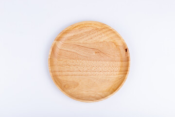 Round plate made of rubber wood on white background