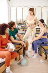 Engaging group of friends enjoying a vibrant pilates studio workout together on a sunny day