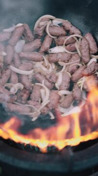 Minced beef meat called cevapi or cevapcici grilled in pan