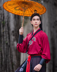 Chinese warriors wearing old traditional costumes. An elegant warrior in a conventional red robe...