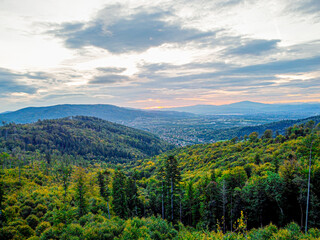 Obraz premium Aerial view of a mountain trail at sunrise under cloudy skies. A scenic landscape capturing the beauty of nature and adventure in misty morning light