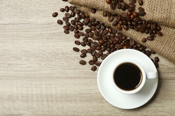 Cuo of coffee with coffee beans on wooden background