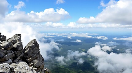Scenic Mountain Top View With Rock Formations and Clouds in Bright Sky