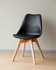 modern chair in black against the wall background