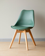modern chair in green against the wall background