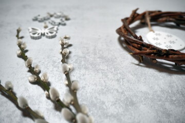 the easter wreath from branches vines with thread on grey background with copyspace. decoration with eggs