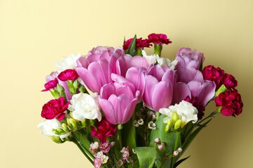 Beautiful bouquet of fresh flowers on a color background