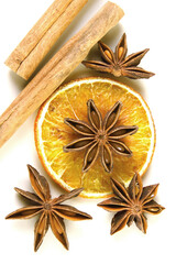 Flavorful spices on a white background. Anise. Cinnamon. A slice of dried lemon. Tea set. Top view. Holiday picture. Postcard. Wallpaper. Background. Photo