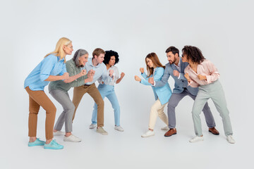 Fototapeta premium Group of professionals in a dynamic pose showcasing teamwork and collaboration against a grey background