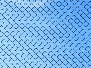 Fototapeta premium chain link fence against blue sky