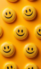 Happy yellow smiley faces on orange background; positive emotions concept; website, social media, blog