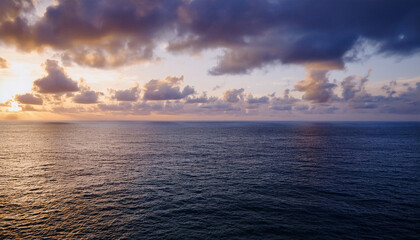 Stunning Seascape Background: Golden Sunrise or Sunset Over Calm Ocean Waters with Colorful Sky and Reflective Light Path - Perfect for Travel, Wellness, and Inspirational Designs